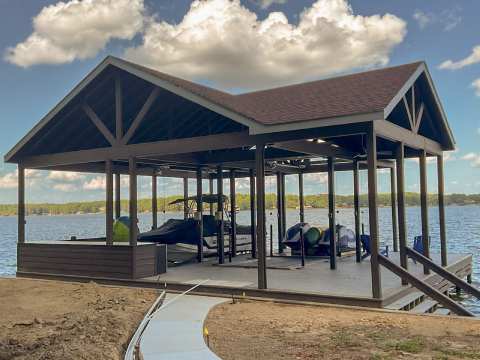 A boat dock with cars parked on the side of it.